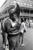 Image of sheet 19780110 photo 13: Tuba Player. Saxophon. Herman Sherman spielt mit seiner Band auf einem Platz in New Orleans Louisiana U.S.A. 1978  Mädchen spielt auf Tambourin mit. 
Herman Edward Sherman, Sr. (June 28, 1923 - September 10, 1984), was an American jazz saxophonist and bandleader.

Sherman was born in New Orleans. He played clarinet in high school and later picked up alto and tenor sax. He began working with brass bands on the New Orleans jazz scene around 1940, playing in the Eureka Brass Band, the Onward Brass Band, and the Young Tuxedo Brass Band. He took over the leadership of the Young Tuxedo Brass Band in 1971 until his death in 1984, and during his tenure the group toured the United States repeatedly and appeared in Berlin in 1980. He led the ensemble in the studio for their 1983 release Jazz Continues on 504 Records. Sherman occasionally played in dance bands, but concentrated on his work in brass bands. He died in his home city of New Orleans. √