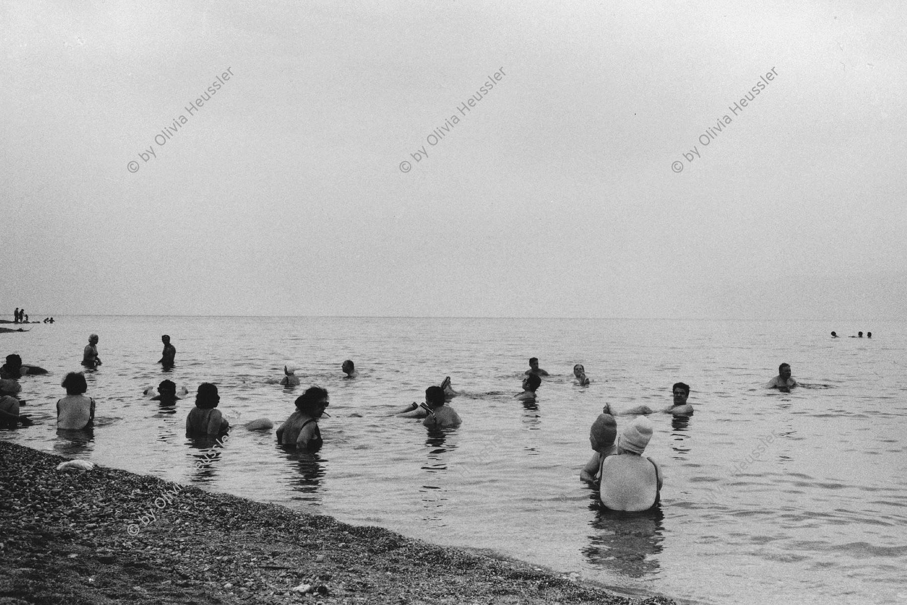 Image of sheet 19800120 photo 26: Das Tote Meer zieht wegen seiner heilenden Wirkung viele Besucherinnen und Besucher aus der ganzen Welt an. Israel 06.80
Aus: Out of Jerusalem / Jenseits von Jerusalem page: 89
Because of its healing powers, the Dead Sea attracts visitors from all over the world. Palestine 1980 √
Palestine by Olivia Heussler
The Dead Sea (Arabic: البحر الميت‎ About this sound al-Baḥr al-Mayyit (help·info),[3] Hebrew: יָם הַ‏‏מֶּ‏‏לַ‏ח, Yām HamMélaḥ, "Sea of Salt", also Hebrew: יָם הַ‏‏מָּוֶת, Yām HamMā́weṯ, "The Sea of Death"), also called the Salt Sea, is a salt lake bordering Jordan to the east and Israel and the West Bank to the west. Its surface and shores are 423 metres (1,388 ft) below sea level,[2] Earth's lowest elevation on land. The Dead Sea is 377 m (1,237 ft) deep, the deepest hypersaline lake in the world. With 33.7% salinity, it is also one of the world's saltiest bodies of water, though Lake Assal (Djibouti), Garabogazköl and some hypersaline lakes of the McMurdo Dry Valleys in Antarctica (such as Don Juan Pond) have reported higher salinities. It is 8.6 times saltier than the ocean.[4] This salinity makes for a harsh environment in which animals cannot flourish, hence its name. The Dead Sea is 67 kilometres (42 mi) long and 18 kilometres (11 mi) wide at its widest point. It lies in the Jordan Rift Valley, and its main tributary is the Jordan River