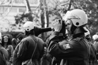 Image of sheet 19800490 photo 33: Auf der Pestalozziwiese findet eine Informationsaktion statt. Die Stadtpolizei lässt die dialogbereiten AJZ-AnhängerInnen, die mit fingierten Auseinandersetzungen ein spontanes Strassentheater mit gemimten PolizistInnen inszenieren, nicht gewähren und verhaftet 144 Personen. Nachdem diese Aktion durch die neue Einkreistaktik der Polizei verhindert worden ist, machen sich in den gemässigten Kreisen der Bewegung Resignation, Enttäuschung und Verzweiflung breit. Polizeibeamte filmt. Film Kamera 

Informationsaktionen: Flugblätter, Strassentheater, Nach Polizeitheater an der siehe Dias, an der Bahnhofstrasse vor dem Globus und auf der Pestalozziwiese werden unter dem Pestalozzi Denkmal 250 Menschen von Polizei in Zivil und uniformiert zusammengepfercht einzeln kontrolliert, registriert, 144 verhaftet und in Sixpacks abgeführt. 
Jugendbewegung Bewegig AJZ Zürcher Jugendunruhen Demonstrationen

Zürich 1980 youth movement √