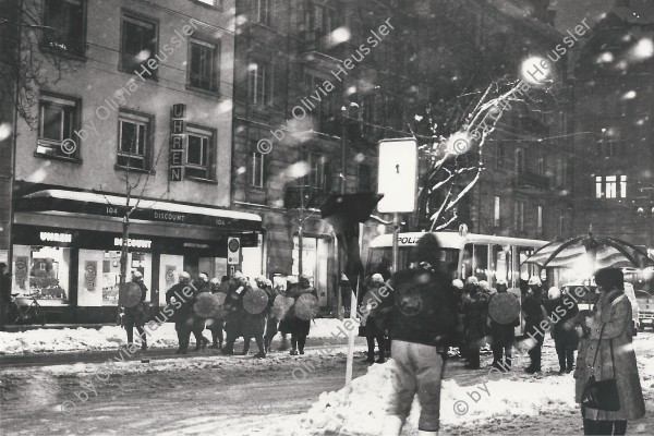 Image of sheet 19800621 photo 32: Luft und Lärm an der Stauffacherstrasse Nacht und Schnee Feuer Aktion auf. Grosse Schneeflocken fliegen auf die den Boden. Schwarze Fahnen im Wind. Ein Autofressendes Monster steht da. Die Polizei steht schon bereit. CV
Jugendbewegung Bewegig AJZ Zürcher Jugendunruhen Demonstrationen
Youth movement Zürich 1980 √