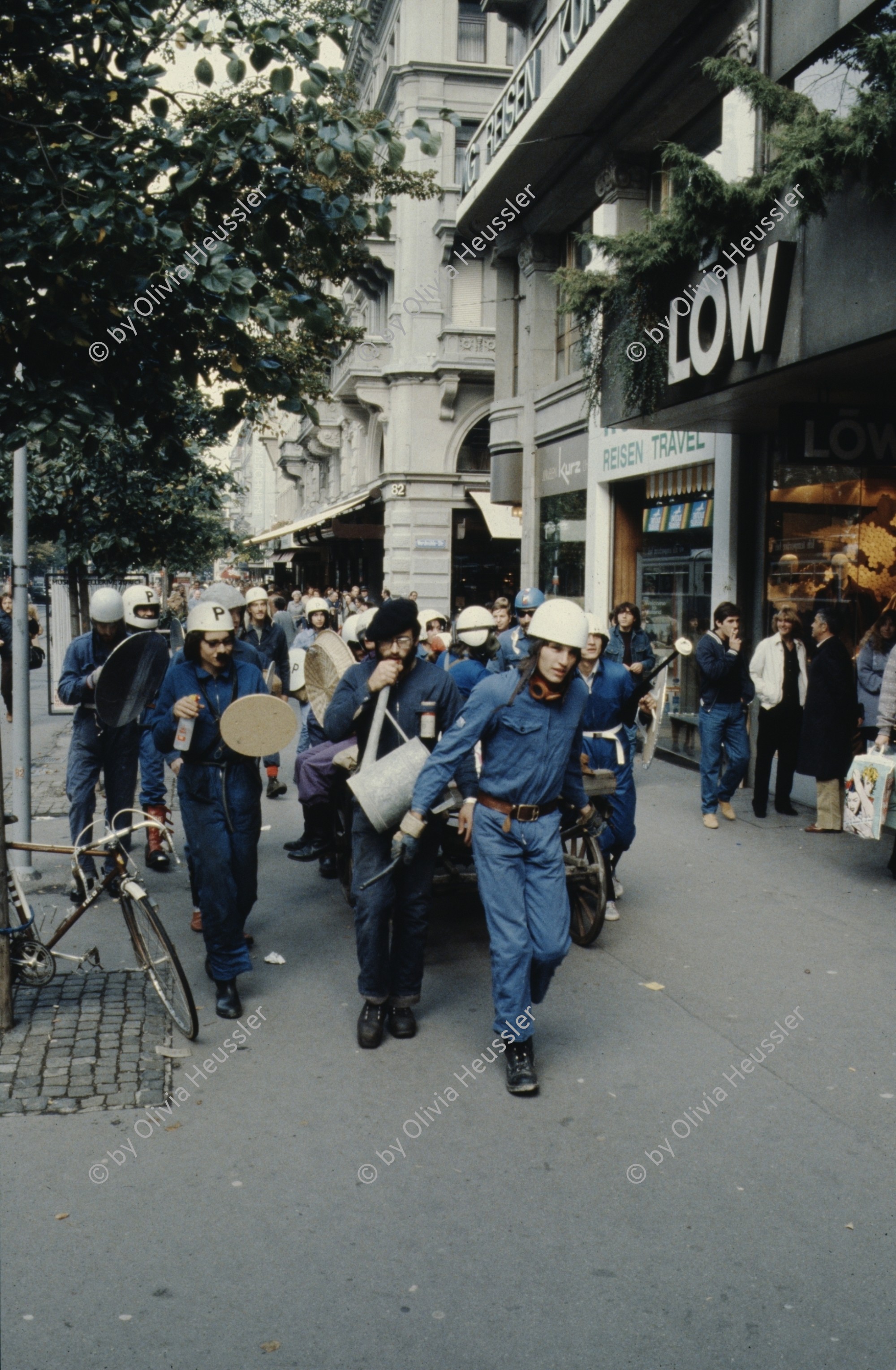 Image of sheet 19803000 photo 41: Jugendliche protestieren in einer Polit Performance, mit Korb-Schilder und Helm als Polizei Grenadiere verkleidet an der Bahnhofstrasse 1980 in Zuerich.
Kreativ Action