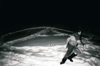 Image of sheet 19830010 photo 2: A anarchismus autonomie im Schnee. Mann rennt vorüber. St. Antönien Winter 1983 √