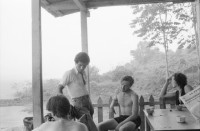Image of sheet 19840110 photo 7: Schweizer Solidaritäts Brigade in Solentiname. Isla Zapotillo. Boot im See. Wäschebank im See. Vater mit Radio und Knabe. Brigadisten Innen fängt Regen mit Hand auf. Junge besprayt Pferd. Campesino auf Pony mit Rinder. Assentamiento Siedlung. In the house of a settlement for war refugees.
Baseballspieler Baseball Asentamiento Strohhütte Kinder stehen vor Palmwedeln Palmen in Siedlung. Laurel y Galan. (Lorbeer) Machetenschleifen. Adobe haus Hacienda. Einfacher Hausbau in Matagalpa. Nicaragua 1984

Aus: Der Traum von Solentiname/The dream of Solentiname/El sueño de Solentiname