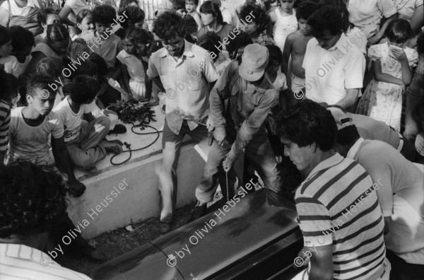 Image of sheet 19840160 photo 32: Barrikade aus Pflastersteinen. Panzer aus Befreiungskrieg. Militärmuseum. Managua. Leo Gabriel mit Sohn und Ehefrau . Beerdigung eines sandinistischen Soldaten. Mädchen tragen Blumen. Familie am Grab und Sarg. Mädchen weint. Tochter, Mutter und Grossmutter trauern. Soldaten trauern. San Juan del Sur Begräbnis von Joé Herrera. Cmdte. Mario Aléman. gest. 1985 Tank Panzer 
banner: Barricada de adoquines principal trinchera de la lucha urbana. Nicaragua 1984
Barricade cobblestone main urban trench fighting.