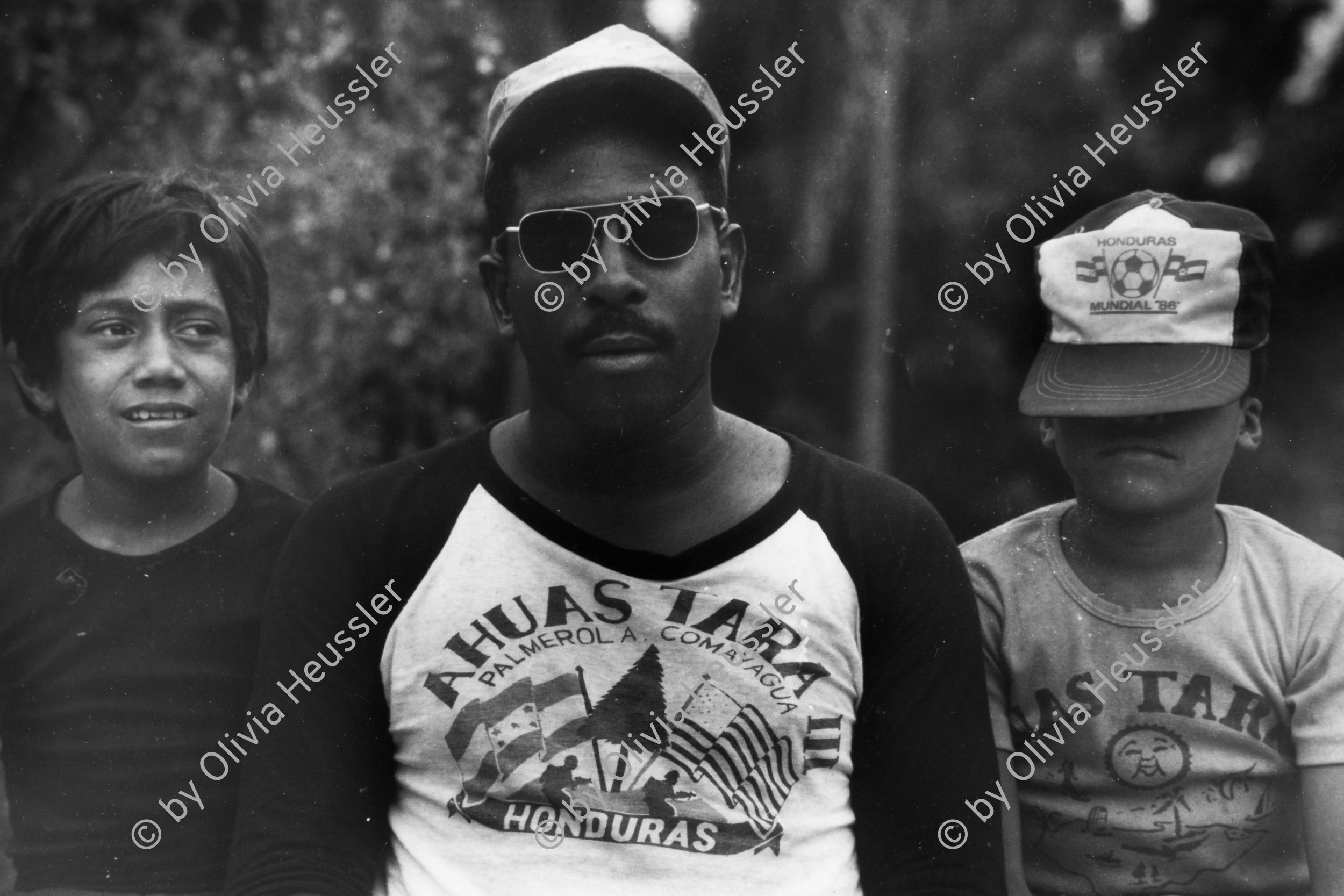 Image of sheet 19840180 photo 25: US-Soldaten warten neben lokalen Kindern, auf ihren Einsatz als Berater und Trainer für Salvadoriansische Soldaten in Honduras 04.84 Auf der Militärbasis Palmerola Comayagua
Honduras Mittelamerika Centralamerica Zentralamerika 1984 √
© 1984, OLIVIA HEUSSLER / www.clic.li