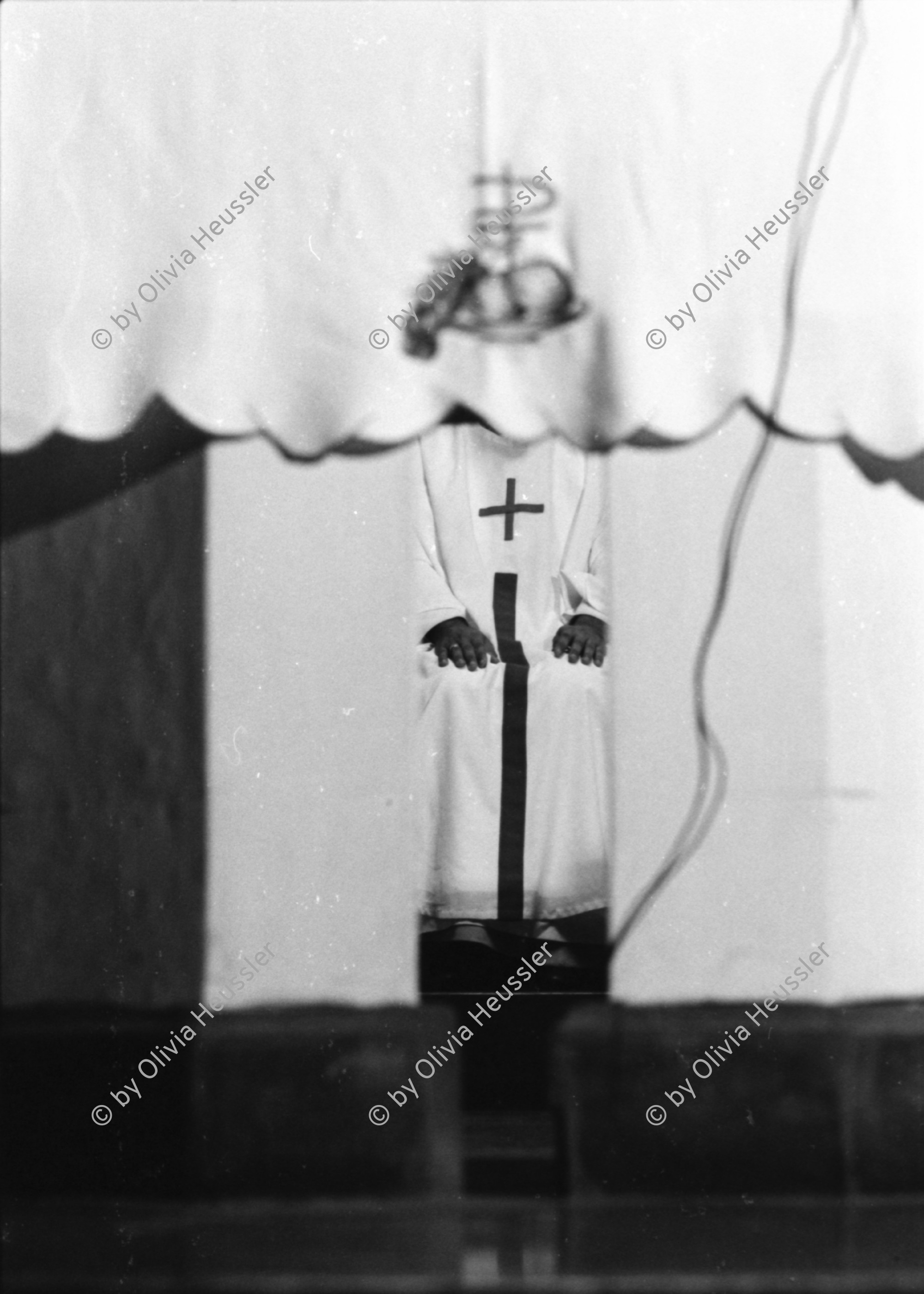 Image of sheet 19840250 photo 8: In der Kirche Don Juan Bosco wird zum 1. Mai eine antisandinistische Rede gehalten. Pablo Antonio Vega Präsident der Bischofskonferenz  in Managua hält die Rede. Amado Peña, que ahora es Capellán del Sistema Penitenciario wird später von den Sandinisten wegen Handel mit Waffen verhaftet. Er trägt eine Shärpe Schal wo drauf steht: Juan Pablo II Nicaragua ist dir treu. Nicaragua 1984