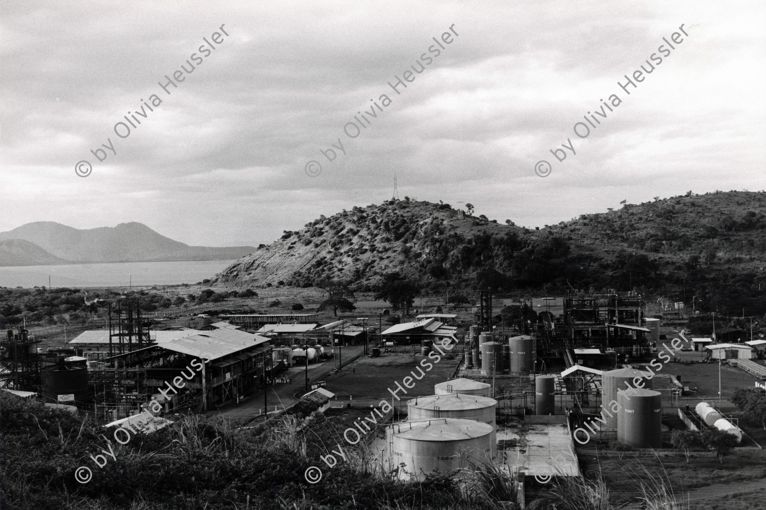 Image of sheet 19840370 photo 18: In der Hercasa Hercules de Centroamerica wird noch Hexachlorocyklohexan (?) ein giftiges Pestizid, dass in Europa und den USA verboten ist, hergestellt. Die Abwasser führen direkt in den Managuasee und tragen zu seiner Verschmutzung bei. Der See ist in hohem Masse mit Quecksilber verunreinigt. Managua Nicaragua 1984 √
Fabrik pesticid inies chemical chemie chemisch