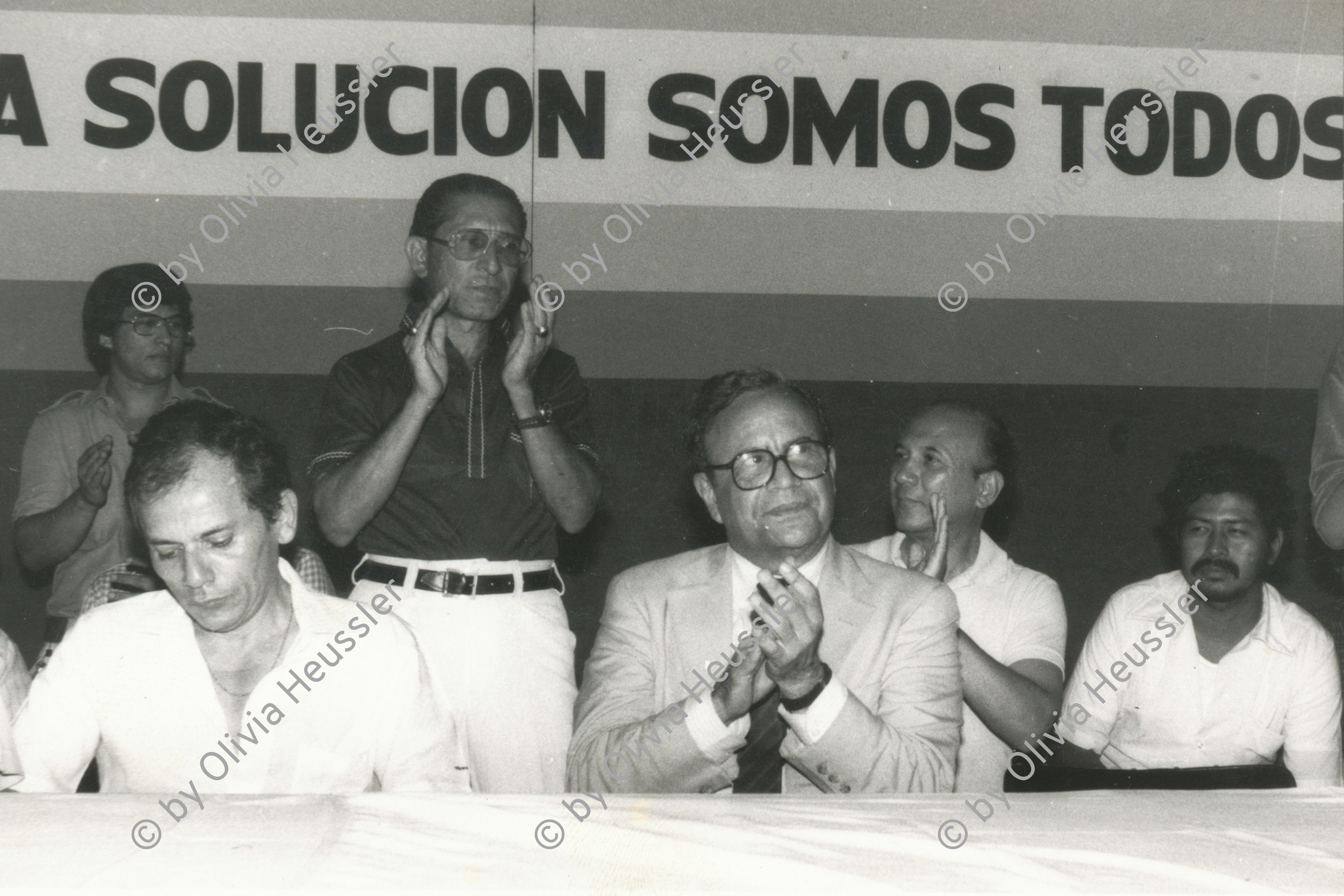 Image of sheet 19840440 photo 24: Gruppenbild Demonstration für den zurückkehrenden Arturo Cruz (center) im Flughafen von Managua Nicaragua  1984 America central √
Demonstration for returning Arturo Cruz at Managua airport A.C. Sandino 

Arturo José Cruz Porras (n. el 18 de diciembre de 1923 en Jinotepe, Departamento de Carazo, Nicaragua) llamado a veces Arturo Cruz padre para distinguirlo de su hijo Arturo Cruz Sequeira, es un banquero y tecnócrata nicaragüense. Fue prominente en política durante la era del gobierno del Frente Sandinista de Liberación Nacional (FSLN), Presidente del Banco Central de Nicaragua (BCN) en 1979 y miembro de la Junta de Gobierno de Reconstrucción Nacional (JGRN) en los años 1980 y 1981
© 1984, OLIVIA HEUSSLER / www.clic.li