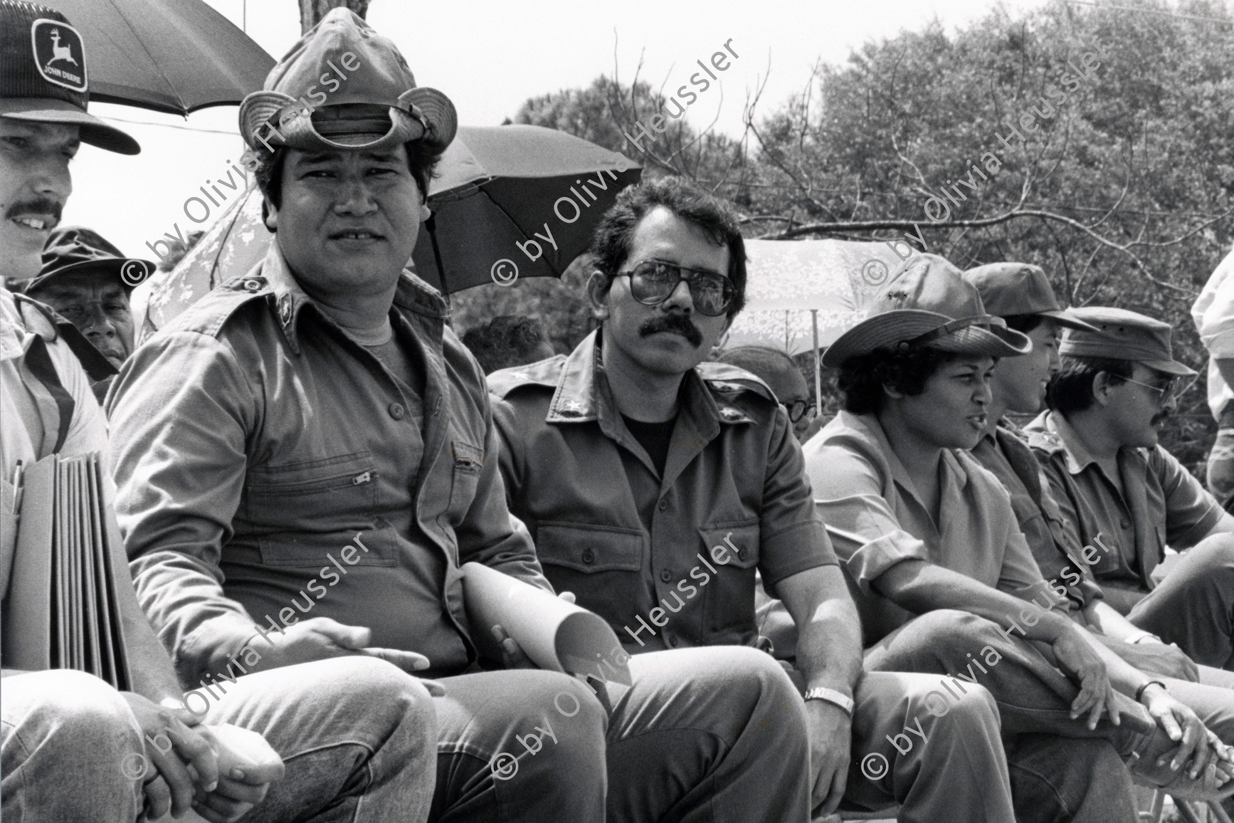 Image of sheet 19840550 photo 29: Kommandant Daniel Ortega Führer der Sandinisten an der Costa Atlantica. Nicaragua 1984 √ 3rd from left Puerto Cabezas RAAN political rally sandinist leader unifomed 

José Daniel Ortega Saavedra (Spanish pronunciation: [xo̞ˈse̞ ðaˈnje̞l o̞rˈte̞ɣa saˈβe̞ðɾa]; born 11 November 1945) is a Nicaraguan politician. He is the current President of Nicaragua (since 2007), a position he has held previously between 1985 and 1990. A leader in the socialist Sandinista National Liberation Front (Frente Sandinista de Liberación Nacional, FSLN), his policies in government have seen the implementation of leftist reforms across Nicaragua.