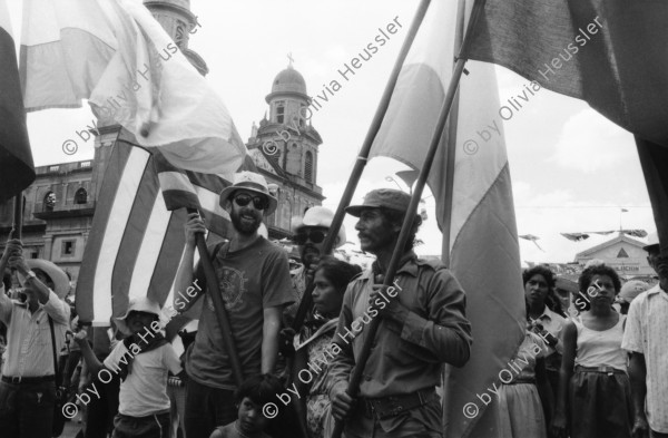 Image of sheet 19840610 photo 27: Nordamerikaner Innen unterstützen sandinistische Bauern der FSLN und der U.N.A.G. US-Amerikanische und Sandinistische Fahnen Flaggen nebeneinander.