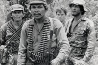 Image of sheet 19850160 photo 24: Männer an der Front Soldat mit Munition Maschinengewehr Gurt um den Körper. Gruppenbild  Cerro 1300. Nicaragua 1985 √ Army Armee EPS Ejército Popular Sandinista Bataillon Battallion Machine Gun Sandinist soldier Military Militär North front Nueva Segovia 

A machine gun is a fully automatic mounted or portable firearm, usually designed to fire bullets in quick succession from an ammunition belt or magazine, typically at a rate of several hundred rounds per minute.

The Sandinista Popular Army (or People's Army; Ejército Popular Sandinista, EPS) was the military established in 1979 by the new Sandinista government to replace the National Guard, following the overthow of Anastasio Somoza Debayle.
