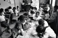 Image of sheet 19850220 photo 31: Miskito Mädchen und Knaben im Kindergarten von Bluefields, lernen die Kinder lesen und schreiben. 

Kids in public-kindergarten.
Bluefields (or Blewfields) is the capital of the municipality of the same name, and of Región Autónoma del Atlántico Sur (R.A.A.S.) in Nicaragua. It was also capital of the former Zelaya Department, which was divided into North and South Atlantic Autonomous Regions. It is located on Bluefields Bay at the mouth of the Escondido River.