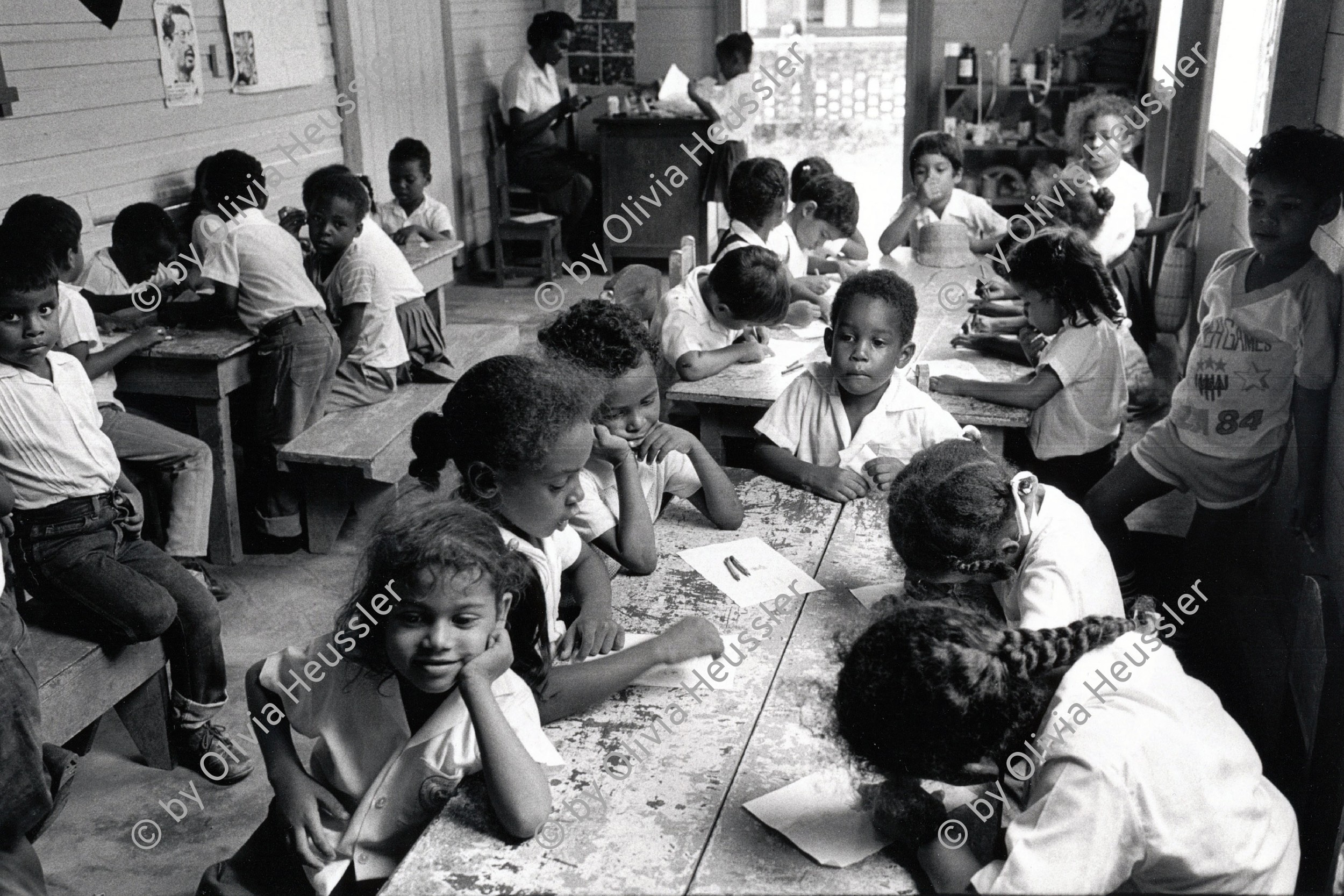 Image of sheet 19850220 photo 31: Miskito Mädchen und Knaben im Kindergarten von Bluefields, lernen die Kinder lesen und schreiben. 

Kids in public-kindergarten.
Bluefields (or Blewfields) is the capital of the municipality of the same name, and of Región Autónoma del Atlántico Sur (R.A.A.S.) in Nicaragua. It was also capital of the former Zelaya Department, which was divided into North and South Atlantic Autonomous Regions. It is located on Bluefields Bay at the mouth of the Escondido River.