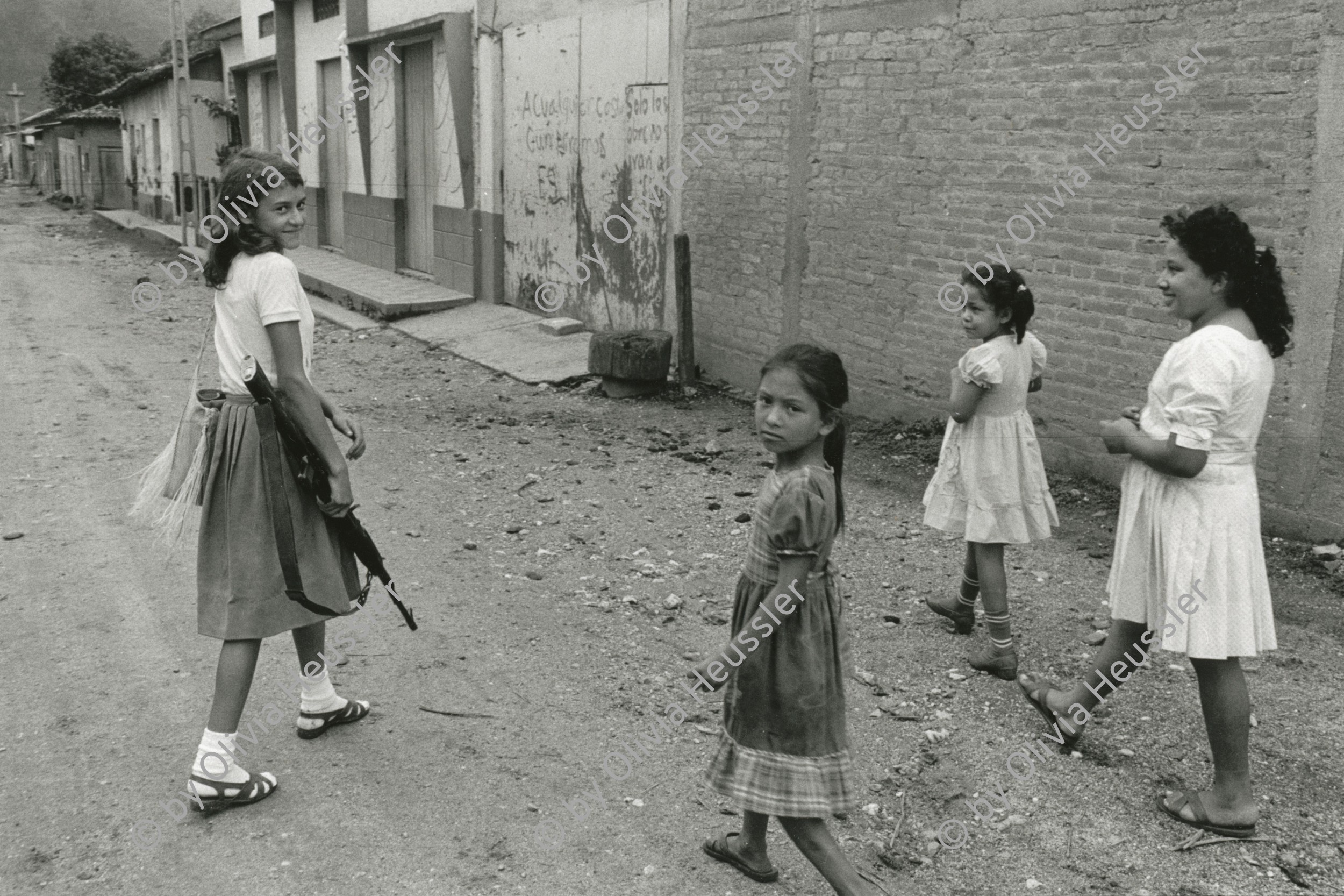 Image of sheet 19850270 photo 26: Flüchtlingsmädchen Mädchen auf dem Heimweg mit Waffe AK-47 im Norden Nicaraguas. Rio Coco Quilali 06.85
Nicaragua 1985 √

The AK-47 is a selective-fire, gas-operated 7.62×39mm assault rifle, first developed in the USSR by Mikhail Kalashnikov. It is officially known as Avtomat Kalashnikova (Russian: Автомат Калашникова). It is also known as a Kalashnikov, an "AK", or in Russian slang, Kalash.