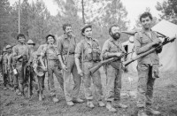 Image of sheet 19850310 photo 3: frtsg. 850300 Der Tag der Demobilisierung des Frauenbataillons Veronica Lacayo nähert sich. Schon sind einige der Soldaten von der Front ins Basislager zurückgekommen. Sie sind ausgelaugt müde und glücklich. Die Männer kriegen nochmals einen Sack Lebensmittel. Kommandant Salvatierra probt mit seiner Kompanie den Schlussakt für Leon. Die Lastwagen werden gefüllt und ab gehts nach Hause, nach Leon, nach 9 Monaten Front Krieg in den Bergen. Eine Rinderherde passiert unsere Karavanne. Die Kirche von X. Daniel Martinez, der chilenische Journalist interwievt die Chefin von Frauenbataillon Veronica Lacayo, Ana Rosa Vargas, für Barricada.
Leon Nicaragua 1985

AK-47 Awtomat Kalaschnikowa, obrasza 47 (kyrillisch Автомат Калашникова образца 47), ein sowjetisch-russisches Sturmgewehr.
Aus: «Der Traum von Solentiname/The dream of Solentiname/El sueño de Solentiname»

The Sandinista Popular Army (or People's Army; Ejército Popular Sandinista, EPS) was the military established in 1979 by the new Sandinista government to replace the National Guard, following the overthow of Anastasio Somoza Debayle.