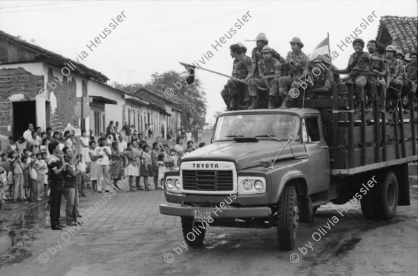 Image of sheet 19850320 photo 5: frtsg. 850310 Die Brücken werden nach Mienen abgesucht. Der Teniente Primero Carlos Morales schaut mir schön in die Camera. Konvoi Militär Die Frauen sandinstisches Bataillon «Veronica Lacayo» reisen übermütig in einem eigenen Lastwagen mitten im Konvoi. Viele schreien fast vor Freude, andere schauen skeptisch an den Berghügeln entlang die Horizonte nach Contras ab. Der Konvoi folgt uns treu. Fahnen werden geschwungen. Die einen steigen aus und tanzen. Freudensmomente am Eingang nach Leon. Wo ist mein Mann, mein Sohn. Die Frauen stehen gespannt am Strassenrand.
Military Army Sandinist Women Soldier
Aus: «Der Traum von Solentiname/The dream of Solentiname/El sueño de Solentiname» Leon Nicaragua 1985
The Sandinista Popular Army (or People's Army; Ejército Popular Sandinista, EPS) was the military established in 1979 by the new Sandinista government to replace the National Guard, following the overthow of Anastasio Somoza Debayle.