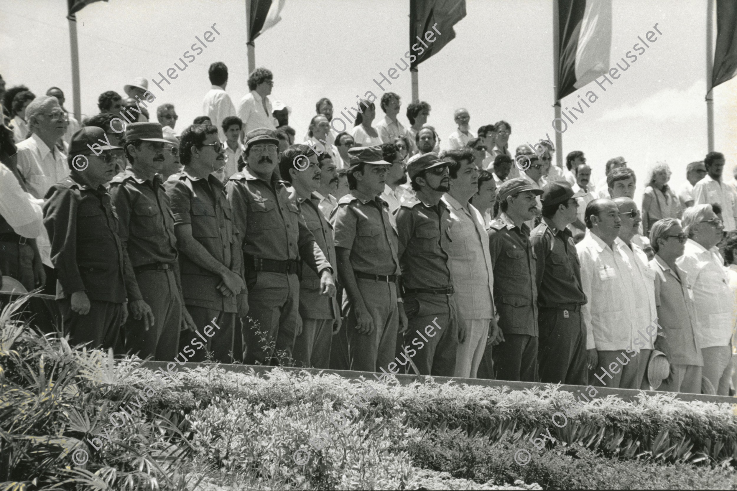 Image of sheet 19850350 photo 23: Die neun sandinistischen Kommandanten u.a. (from left to right) 1.v.l. Tomas Borge, 2. v.l. Victor Tirado, 3.v.l. Kommandant der Revolution Daniel Ortega 4. v.l. Humberto Ortega, 5. v.l. Henry Ruiz, 6. v.l. Jaime Wheelock, 7. v. l. Bayardo Arce , 8. v.l. Sergio Ramirez Mercado, 9 v.l. Carlos Núñez, 10. v.l. Javier Carrion, during the celebration of the 6th aniversary of the Revolution Sandinist. während der Feierlichkeiten zum 6. Jahrestag der Revolution. Managua Nicaragua 19.07.85 1985
The nine sandinist commandants during celebration of the 6th aniversary of revolution. √
