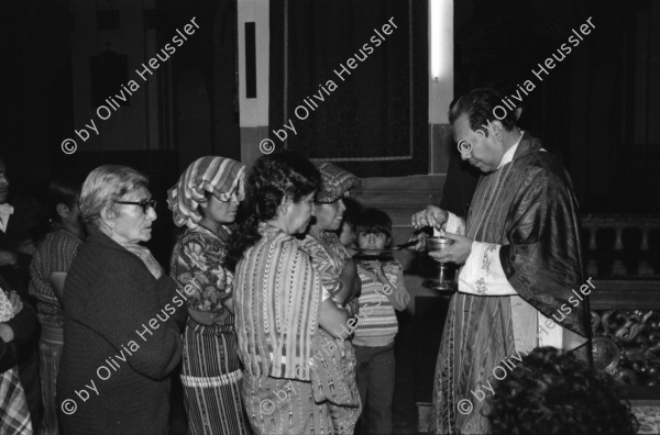 Image of sheet 19850490 photo 18: Präsidentenkarosse fährt vorbei. Ein Mann scheisst an eine Wand auf dem National Palast Platz. 
Nineth de Garcia Montenegro is one of the founders of the Mutual Support Group (Grupo Apoyo Mutuo, or GAM) for relatives of the disappeared. Her husband Fernando was abducted three months before. But this group is not being formed simply to hold hands. They are supporting each other to protest the injustice of the disappearances.
Nineth de Garcia Montenegro besetzt mit ihrer Gruppe Grupo Apoyo Mutuo (GAM) die Kathedrale und protestiert gegen die Politik ihres Landes. Portrait. (Bild via AP) Guatemala 1985