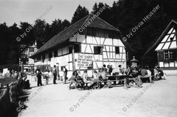 Image of sheet 19870270 photo 27: Besetzung des Freilicht Museums Ballenberg. am Eidg. Bettag. durch Protest Demonstration gegen die Wohnungsnot in Zürich. BesucherInnen in Trachten bestaunen die Transparente. «Die Häuser den Menschen die darin wohnen» Oder:«Die einen sind am Ballen die anderen stehen am Berg» Am Riegelhaus. Olivia nach Weisheits Zahn entfernung. Selbstportrait. 1987 Zürich Bern

Ballenberg is an open air museum in Switzerland that displays traditional buildings and architecture from all over the country. Located near Brienz in the municipality of Hofstetten bei Brienz, Canton of Berne, Ballenberg has over 100 original buildings that have been transported from their original sites