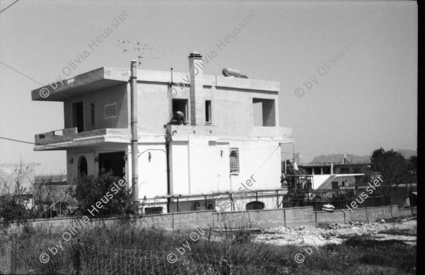 Image of sheet 19880330 photo 33: Plakate mit Frauenfeindlicher Reklame. Im Erismannhof steht Hallo Margrit du schöne Frauen - Wandmalerei. ABB Reklame im Flughafen Zürich. 
In Kreta mit Rudi Berli. Portrait. Frau studiert Todesanzeigen. Plakat der Nea Democratica. Mit Cathy auf dem Boot. mit Costa. Portrait Olivia. Haus typisch. Cathy und Mann X am Strand. Touristen Souvenir auf Autokühlerhaube. Dorf. Xania
Griechenland 1988