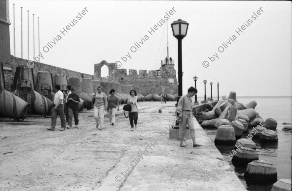 Image of sheet 19880340 photo 25: frtsg. 880330 Osterfeier mit Cathy in Galatas mit Takis mara und Tasso Szene im Dorf. Plakat eines ermordeten jungen Autonomisten. Xania Erinnerungen an den Krieg. Touristenmenu werden vorgestellt. Am Hafen die Wellenbrecher. Grosse aus Beton gegossene Wellenbrecher. Junge verkauft Nüsse. Cathy und Rudi Leeres Haus. Eingang einer Hütte  Hauswand politische Wandmalereien Spray Graffitti mit Anarchisten A Portrait Mara. Kreta Griechenland 1988 crete greece