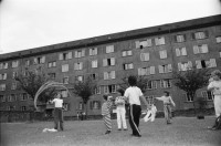 Image of sheet 19880411 photo 16: Susan Büchi malt ein Transparent und Dorothea Hunziker. Wäsche hängt im Erismannhof Innenhof städtische Siedlung Erismannhof Kinder spielen mit Papier Kugeln. 
Die Siedlung vor dem Umbau mit Kinder im Vordergrund.
Zürich 1988