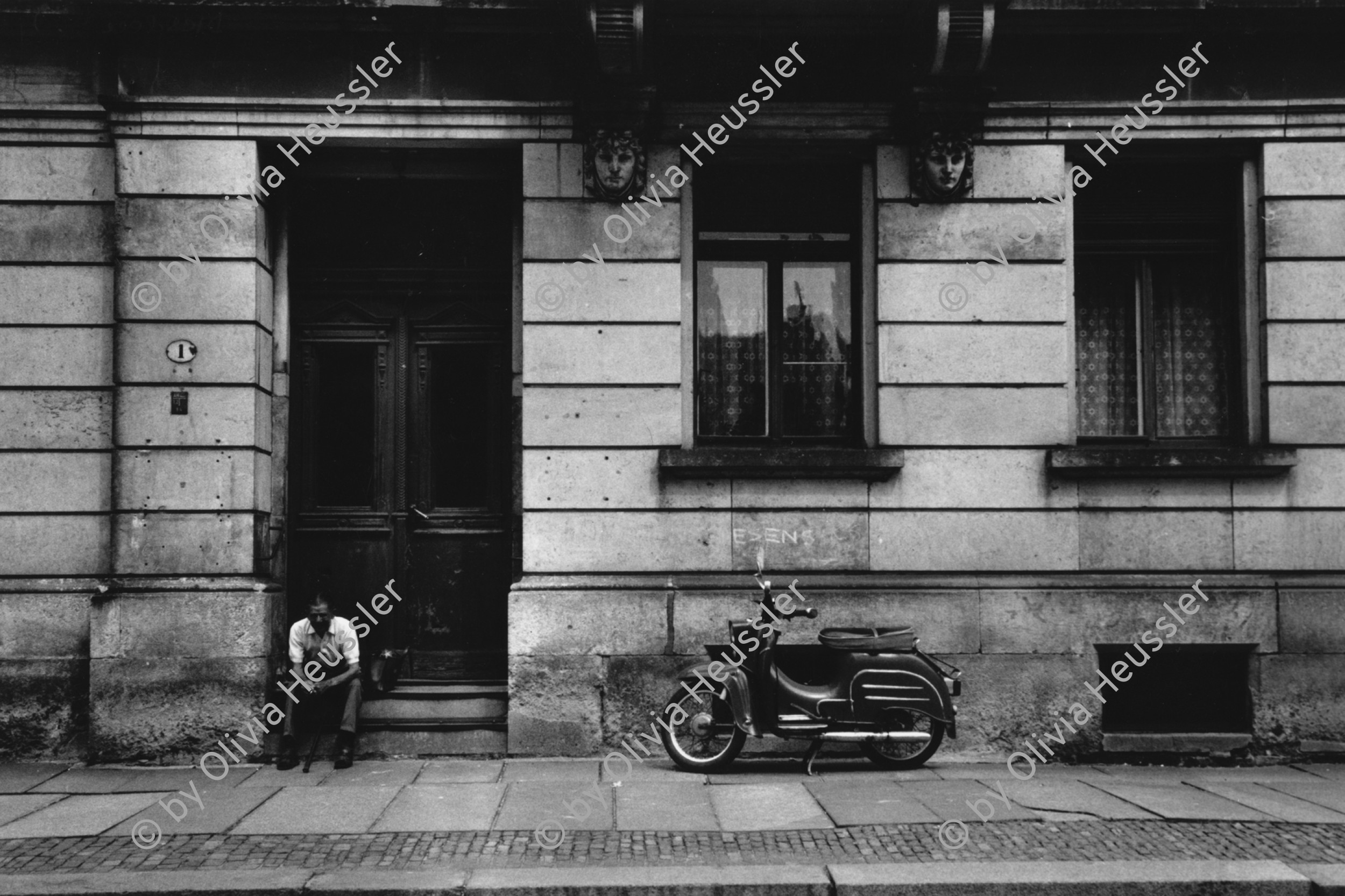 Image of sheet 19880694 photo 33: Leere Strassen.
Einkauf Laden. Mann sitzt vor altem Wohnhaus. Mofa Motorrad Motorroller
Dresden Ostdeutschland 1988 √ DDR GDR
East Germany