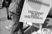 Image of sheet 19890370 photo 1: Frau steht eingepackt in der Sonne. Welteinheit durch Weltordnung' steht da auf einer Tafel einer religiösen Sekte. Ein Karton AKW wird an der Demonstration gegen Atomkraftwerke herumgetragen. Transparent: 'Für die sofortige Stilllegung der herrschenden Klasse' Portrait von Viktor Braun. Giovanni Schuhmacher mit Fahne und dem Anarchisten A vor Bundeshaus in Bern. Eine Frau muss über die Abschrankung der Polizei auf den Bundeshausplatz steigen . Meine Bilder im Hotel Bern. Nicaragua von sieben Schweizer Photographen und Photographinnen. Reithalle Interieur Skateborder Bern 1989