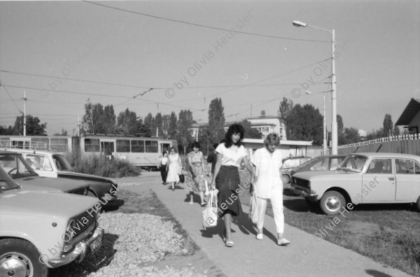 Image of sheet 19890650 photo 27: Eine Bauern-Familie posiert für mich auf dem Gehsteig, nachdem
 sie mich mit Gemüse beschenkt haben. Auf dem Rückweg nach Sofia.
 Ein Orthodoxer auf dem Kirchenplatz in Sofia. Die Moschee in
 Sofia. Ein Mann spritzt die Pflanzen. Zwei alte Männer betrachten
 die Preise für den Kohl. Maler bei der Arbeit. Mercedes Benz.
 Vater und Sohn auf einer Parkbank. Maja Wicki und Djanko und
 Olivia und Maja auf dem Vitussi. Mädchen benützt Grossmutter als
 Gummitwist Halterin. Im Hotel (Nr. 22)steht Maja nach einem
 schlechten Traum wie ein Gespenst da. Bus Nr. 83 Endstation. Die
 Frauen und Männer gehen zur Arbeit in die Fabriken am Stadtrand
 von Sofia. Ziege spaziert. Die zwei Roma bei ihrer Arbeit als Kesselflicker in Razgrad. Bulgaria Bulgarien 1989