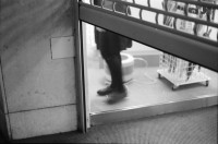 Image of sheet 19890860 photo 16: Demonstration im Kasernen Innenhof. Modepuppe sitzt an Nähmaschine im Freien. In einem Lebensmittelladen für TürkInnen. Asyl bewerber Innen. Uniformen hängen da, während Männer essen. Zwei Frauen stehen da. Unbekannte Gestalt beim Telefonieren in Telefon Kabine. Schliessung eines Ladens. Zwei Männer als Türkisches Beschneidung fest in einer Turnhalle in Pratteln. Frauen und Kinder und Männer tanzen zusmmen . Basel Brauchtum turkish boy circumcision child tradition muslim religion asylum seekers human rights Switzerland Schweiz 1989