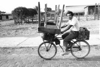 Image of sheet 19900380 photo 23: Ein Mann kehrt mit seinem  Markttisch auf dem Fahrrad vom Markt nach Hause zurück.
Velo