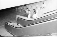 Image of sheet 19900420 photo 12: Mann liegt auf Rolltreppe, Bukarest, Rumänien 1990.