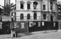 Image of sheet 19900510 photo 1: Ich gehe mit Tomo Muscionico durch die Strassen und fotografiere ihn wie er ein kleines Mädchen vor einer Plakatwand (und zerschossenem Haus) ablichtet. Im Hotel schläft auch Nachtway auf einem Stuhl und er wird gefilmt! Kult. Auf dem Universitätsplatz Demonstration Protest 'Revolutia Continua' Menschen stehen vor Lautsprecher und Transparent Hotel Bucuresti. Grossvater Mihai und Blanca im Schoss ihrer Urgrossmutter. In Sibiu ist die erste öffentliche Orthodoxen Zelebrierung auf der Strasse. Rumänien Romania Rumania 1990

The Roma (Roma in Romani; Romi or Țigani in Romanian) constitute one of the largest minorities in Romania. According to the 2011 census, they number 619,007 people or 3.2% of the total population, being the second-largest ethnic minority in Romania after Hungarians. The Roma are Romania's most socially and economically disadvantaged minority, with high illiteracy levels