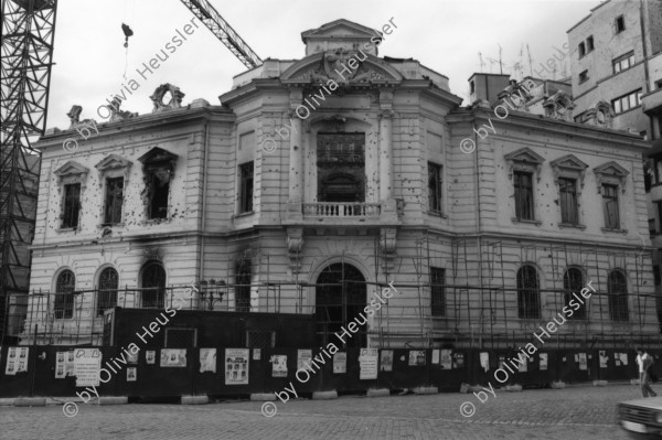 Image of sheet 19900510 photo 10: Ich gehe mit Tomo Muscionico durch die Strassen und fotografiere ihn wie er ein kleines Mädchen vor einer Plakatwand (und zerschossenem Haus) ablichtet. Im Hotel schläft auch Nachtway auf einem Stuhl und er wird gefilmt! Kult. Auf dem Universitätsplatz Demonstration Protest 'Revolutia Continua' Menschen stehen vor Lautsprecher und Transparent Hotel Bucuresti. Grossvater Mihai und Blanca im Schoss ihrer Urgrossmutter. In Sibiu ist die erste öffentliche Orthodoxen Zelebrierung auf der Strasse. Rumänien Romania Rumania 1990

The Roma (Roma in Romani; Romi or Țigani in Romanian) constitute one of the largest minorities in Romania. According to the 2011 census, they number 619,007 people or 3.2% of the total population, being the second-largest ethnic minority in Romania after Hungarians. The Roma are Romania's most socially and economically disadvantaged minority, with high illiteracy levels