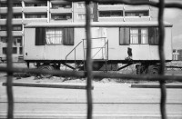 Image of sheet 19900681 photo 27: Carlo Edi Hebeisen Kanzleiturnhalle Nachts. Ost Berlin DDR GDR Alexanderplatz. S-Bahnhof. BMW Total Schaden Unfall. Trabant. In der Beratungsstelle für Vietnamesische Arbeitnehmer Innen, Nguyen Luu Huong Quang, mit seiner Tochter. 1143 Berlin Marzahn Schorfheidestr. 6/0203. Postadresse: Tamara Hentschel (Beyreiss) Belziger Ring 21/0604 1143 Berlin Marzahn Nord. Berlin former GDR
 engl.
Nguyen Luu Huong Quang is sitting in his information office for Vietnamese workers in East Germany. Quang built up this information office without any help from the East-German state. Apart from this job he is also a considerate father and looks after his daughter.
