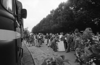 Image of sheet 19900730 photo 30: © 1990, OLIVIA HEUSSLER / www.clic.li
Am Checkpoint Charlie in Berlin verkaufen Polen alte DDR Uniformen und Flaggen etc. Im Hintergrund steht 'Neue Zeit'. Verkäufer ist uniformiert.  
Former Checkpoint Wallborder to East-Germany GDR. An Polish Citizen  near old military uniforms from various Eastern Countries. The Pole is selling these uniforms to travellers who visit whatever is left over from the 'Wall'.

Deutschland 1990 √

Checkpoint Charlie (or Checkpoint C) was the name given by the Western Allies to the best-known Berlin Wall crossing point between East Berlin and West Berlin during the Cold War.

The Soviet Union prompted the erection of the Berlin Wall in 1961 to stem the flow of Eastern Bloc emigration westward through what had become a loophole in the Soviet border system, preventing escape over the city sector border from East Berlin to West Berlin. Checkpoint Charlie became a symbol of the Cold War, representing the separation of east and west, and—for some East Germans—a gateway to freedom. Soviet and American tanks briefly faced off at the location during the Berlin Crisis of 1961.