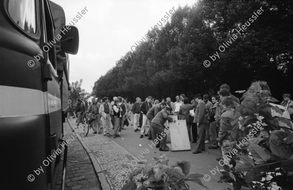 Image of sheet 19900730 photo 30: © 1990, OLIVIA HEUSSLER / www.clic.li
Am Checkpoint Charlie in Berlin verkaufen Polen alte DDR Uniformen und Flaggen etc. Im Hintergrund steht 'Neue Zeit'. Verkäufer ist uniformiert.  
Former Checkpoint Wallborder to East-Germany GDR. An Polish Citizen  near old military uniforms from various Eastern Countries. The Pole is selling these uniforms to travellers who visit whatever is left over from the 'Wall'.

Deutschland 1990 √

Checkpoint Charlie (or Checkpoint C) was the name given by the Western Allies to the best-known Berlin Wall crossing point between East Berlin and West Berlin during the Cold War.

The Soviet Union prompted the erection of the Berlin Wall in 1961 to stem the flow of Eastern Bloc emigration westward through what had become a loophole in the Soviet border system, preventing escape over the city sector border from East Berlin to West Berlin. Checkpoint Charlie became a symbol of the Cold War, representing the separation of east and west, and—for some East Germans—a gateway to freedom. Soviet and American tanks briefly faced off at the location during the Berlin Crisis of 1961.