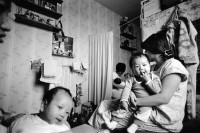 Image of sheet 19900770 photo 20: Vietnamesische Vertragsarbeiterinnen mit ihren Babys nach ihrer Entlassung, Berlin DDR vor der Wende, 28. September 1990. Vietnamesische Fremdarbeiter Vertragsarbeiter Innen aus Vietnam als Textilnäherinnen in VEB Fortschritt Herrenbekleidung tätig. Im Wohnheim an der Rhinstrasse 91 D,Zimmer 5, Berlin 1136 Friedrichsfelde Ost. mit ihren Kleinkindern. Sie wohnen zu dritt mit ihren Kindern im selben Zimmer , abgetrennt mit Vorhängen. Die Väter der Kinder sind unbekannt. Die Frauen werden alle ausgeschafft.
 
 their work-situations as well as information on possibilities to
 learn German, was very high. The general situation has worsened during the last months due to massdismisalles , because of measures seeking higher profits. The future of the Vietnamese industrial sewers for male clothing.
 working at the VEB Fortschritt is very unsure.As far as the living situation of these young mothers is concerned, they have to live on very little space and the cost of living is getting higher every day due to the political change.
Berlin Deutschland Germany 1990 √ baby women woman children 

© 1990, OLIVIA HEUSSLER / www.clic.li