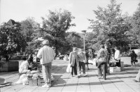 Image of sheet 19900770 photo 4: Strassenverkäufer in Pankow. Vietnamesische Fremdarbeiter Vertragsarbeiter Innen aus Vietnam als Textilnäherinnen in VEB Fortschritt Herrenbekleidung tätig.
 Im Wohnheim an der Rhinstrasse 91 D,Zimmer 5, Berlin 1136
 Friedrichsfelde Ost. S-Bahn. mit ihren Kleinkindern. Sie wohnen
 zu dritt mit ihren Kindern im selben Zimmer , abgetrennt mit
 Vorhängen. Die Väter der Kinder sind unbekannt. Die Frauen werden
 alle ausgeschafft.
Büro der Ausländerbeauftragten beim Ministerrat der DDR. Beratungsstelle für jüdische Emigranten.
 Im ehemaligen Reichsluftfahrtministerium fragen sovietische russische Juden und Jüdinnen um Asyl. Eine alte Frau schläft erschöpft auf ihrem Gepäck. Otto Grothewohlstr. 19 D
Reichspropaganda Ministerium. Das Reichsluftfahrtministerium (RLM) war ein Ministerium in der Zeit des Dritten Reichs. Für dieses Ministerium wurde 1935 ein monumentales Bürogebäude in Berlin errichtet, das seit 1992 Detlev-Rohwedder-Haus heißt und heute Sitz des Bundesministeriums der Finanzen ist.
Nguen Lun Huong Quang right, works at the advice centre for Vietnamese migrant workers in East-Berlin, former GDR. The advice centeris provisional and was set up very fast, because the demand for legal advice, how to avoid dismissalles , in connection with
 their work-situations as well as informationon possibilities to
 learn German, was very high.
 The general situation has worsened during the last months due to
 massdismisalles , because of measures seeking higher profits.
 The future of the Vietnamese industrial sewers for male clothing.
 working at the VEB Fortschritt is very unsure.As far as the living situation of these young mothers is concerned, they have to live on very little space and the cost of living is getting higher every day due to the political change.
Berlin 1990