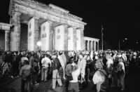 Image of sheet 19900790 photo 2: Der Reichstag in der Wiedervereinigungs Nacht. Durch TV Kamera. Jubelnde Menge am Brandenburger Tor. Nacht. 'Europa ohne Armee Deutschland zuerst 1914 1939 1990' Transparent. Helm und Schaf Maske. Portrait Larry Boyd in Berlin. Polizei kontrolliert und durchsucht  Demonstranten Innen gegen Wiedervereinigung. Grenadiere Transparent 'Gegen Rassismus und Grossdeutschland. 
Young left-winged activist is covering his face with his hand to keep his identity from whoever tries to take pictures from him. This reaction is the consequence of continuing police control in Berlin s streets. Especially as there is also a Anti Reunification Movement in Berlin Deutschland 1990
