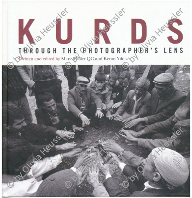 Image of sheet 19901010 photo 10: Die Bauern wärmen sich nach der Beerdigung ihre Hände über dem Feuer. Lice Türkei Kurdistan 12.90
fyer farmer warming up hands Kurds grave Turkey 
ohne Aufkleber


Aus: von Zeit zu Zeit Out of: from Time to Time
Kurdish peasents, warming their hands in sorrow during the funeral of Kudret Filiz (27) who had been killed by the Turkish army. Kudret had participated in a manifestation against the Turkish policy in Kurdistan an been shot.

Lice (pronounced [ˈlidʒe]), (Kurdish: Licê) is a Kurdish district of Diyarbakır Province in Turkey. The population is 9,644 as of 2010. It is located 90 km (56 mi) from the capital, Diyarbakır. 

Türkei Kurden Kurdistan Kurdish Turkey Turkish 1990 √

cover of: Kurds through the photographer's lens
http://www.amazon.com/Kurds-Through-photographers-Mark-Muller/dp/1904563864



book cover.