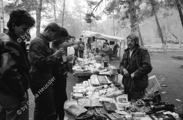 Image of sheet 19901070 photo 29: Peschmerga verkaufen an der alten Stadtmauer von Diyarbakir importierte Billigwaren für einen Zwischenhändler. Schrott. market shop open street 
Irakische Kurden leben als Flüchtlinge in Diyarbakir. Iraqi kurdish refugees in Turkey.
Kurds Kurdish Turkey Türkei Kurdische Ostanatolien 1990 √


Peshmerga or Peshmerge (Kurdish: پێشمەرگە Pêşmerge) is the term used by Kurds to refer to armed Kurdish fighters. Literally meaning "those who face death" (Pesh front + marg death) the Peshmerga forces of Kurdistan have been in existence since the advent of the Kurdish independence movement in the early 1920s, following the collapse of the Ottoman and Qajar empires which had jointly ruled over the area. Peshmerga forces include women in their ranks. Many Kurds will say that all Kurds willing to fight for their rights are Peshmerga. The term remains in contemporary usage, sometimes written as pesh merga in Anglophone media.
© 1990, OLIVIA HEUSSLER / www.clic.li