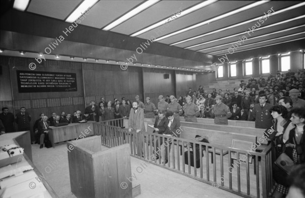 Image of sheet 19901090 photo 20: Staatssicherheitsgericht. Prozess gegen die kurdischen Anwälte: Vedat Aydin, Zeki Okçuoğlu und Mustafa Oezer.  Die angeklagten kurdischen Anwälte v.l.n.r. Vedat Aydin, Ahmet Zeki Okçuoğlu, und Mustafa Oezer während einem Prozess im Ankaraer Staatsgericht stehen vor dem Staatsrichter in der Anklagebank. Kurds Kurdish Turkey Ankara Dec. 1990 

Vor dem Eingang des Staatssicherheitsgericht.

Lissy Schmidt (am 3.4.94 im Irak umgebracht) a German freelance journalist who worked with Agence France-Presse and the German newspapers Frankfurter Rundschau and Der Tagesspiegel, and a friend were shot and killed when gunmen opened fire on their car outside the city of Sulaymaniyah in the Kurdish-controlled area of northern Iraq.-
Dort fotografierte ich den Staatsrichter, was er nicht mochte und protestierte. Eine junge Verteidigerin sprach für mich ein Plädoyer.
Nr. 36 Mustafa Oezer steht in der Anklagebank. 
Türkei Kurdische Ostanatolien √