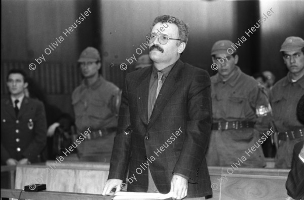 Image of sheet 19901100 photo 9: frtsg. 901090 Im Staatsgericht Ankara. Der Prozess um den kurdischen Anwalt Vedat Aydin Nr. 5, der im Juli 91 von Todesschwadronen umgebracht wurde. Im Prozess wurden alle drei wegen Kurdisch sprechens verklagt, und später frei gesprochen. Mi: Ahmet Zeki Okçuoğlu, und re: Mustafa Oezer (HEP). In der Anklagebank. Umringt von türkischen Militärs. Die Verteidiger Innen, über 100, zogen sich unter Protest zurück und führten später ihre Plädoyer aus dem Zuschauerraum. Turkey Kurdish Kurds
Die angeklagten kurdischen Anwälte v.l.n.r. Vedat Aydin, 

(Vedat Aydın, the Diyarbakır branch chairman of the now-defunct People’s Labor Party (HEP), was found dead on a road near Malatya on 7 July 1991, two days after armed men had taken him from his home in Diyarbakir. The widow Sükran Aydın thinks her husband’s murder was a turning point and that there was a sudden increase in the number of unsolved murders in the country’s Southeast following his death. She believes that a clandestine unit within the gendarmerie was responsible for the murder.[48] Only 18 years after the killing the public prosecutor in Diyarbakir opened a file seeking the detention of nine JITEM members including the Major Aytekin Özen)



Ahmet Zeki Okçuoğlu, und Mustafa Oezer während einem Prozess im Ankaraer Staatsgericht. Ahmet Zeki Okçuoğlu, ist 1999 einer der Verteidiger im Prozess gegen den Kurdenführer Oecalan. Öcalan Ankara Türkei 12.90