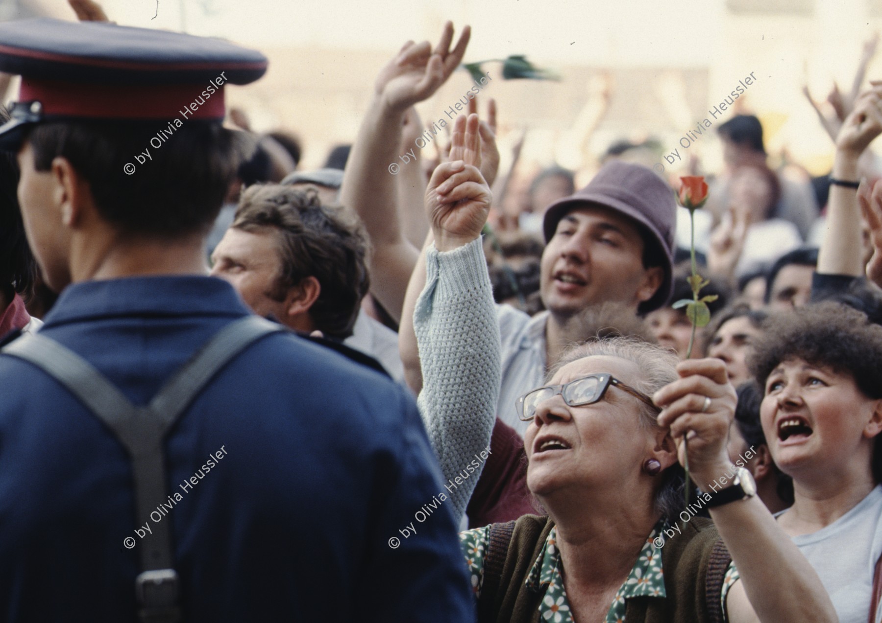 Image of sheet 19903002 photo 12: Angehörige des FSN (Frontul Salvari National) demonstrieren mit Blumen für die Unterstuetzung Ion Illiescus, Brasov Rumaenien, 1990.

Flowers in front of the policemen, from the fanatical part of the electoral rally of Iliescu.