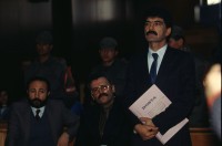 Image of sheet 19903006 photo 22: Prozess gegen drei kurdische Anwälte in Ankara, kurdische Türkei 1990.

 Im Staatsgericht Ankara. Der Prozess um den kurdischen Anwalt Vedat Aydin Nr. 5, der im Juli 91 von Todesschwadronen umgebracht wurde. Im Prozess wurden alle drei wegen Kurdisch sprechens verklagt, und später frei gesprochen. Mi: Ahmet Zeki Okçuoğlu, und re: Mustafa Oezer (HEP). In der Anklagebank. Umringt von türkischen Militärs. Die Verteidiger Innen, über 100, zogen sich unter Protest zurück und führten später ihre Plädoyer aus dem Zuschauerraum. Turkey Kurdish Kurds Die angeklagten kurdischen Anwälte v.l.n.r. Vedat Aydin, (Vedat Aydın, the Diyarbakır branch chairman of the now-defunct People’s Labor Party (HEP), was found dead on a road near Malatya on 7 July 1991, two days after armed men had taken him from his home in Diyarbakir.