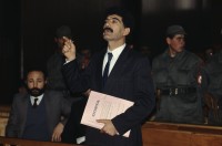 Image of sheet 19903006 photo 31: Im Staatsgericht Ankara. Der Prozess um den kurdischen Anwalt Vedat Aydin Nr. 5, der im Juli 91 von Todesschwadronen umgebracht wurde. Im Prozess wurden alle drei wegen Kurdisch sprechens verklagt, und später frei gesprochen. Mi: Ahmet Zeki Okçuoğlu, und re: Mustafa Oezer (HEP). In der Anklagebank. Umringt von türkischen Militärs. Die Verteidiger Innen, über 100, zogen sich unter Protest zurück und führten später ihre Plädoyer aus dem Zuschauerraum. Turkey Kurdish Kurds Die angeklagten kurdischen Anwälte v.l.n.r. Vedat Aydin, (Vedat Aydın, the Diyarbakır branch chairman of the now-defunct People’s Labor Party (HEP), was found dead on a road near Malatya on 7 July 1991, two days after armed men had taken him from his home in Diyarbakir.