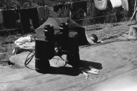 Image of sheet 19910600 photo 37: Feldstecher Spiegel steht auf dem Tisch. Miklos Magosch  (31.10.1946 - 25.5.2012) liegt unter Sonnenschirm vor der Hütte.
Alp Grava Kanton Graubünden 1991 √
 alp farming bio Switzerland alps mountain farm cheese Europe Schweiz Svizzera fyer place swiss traditional farming biological stecher field telescope regenschirm umbrella man sleeping in the sun shine 
ohne Aufkleber