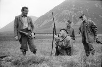 Image of sheet 19910710 photo 36: Vital Hauser lädt ein zur Hirschjagd in Gaick Lodge bei Kingussie. Wir kommen in Inverness an. Flughafen. Die Jagd Touristen vorallem aus den USA warten mit den Waffenscheinen auf ihr Gewehr. Lachs wird angeboten. Portrait Vital. Lange Koffer
sind für Gewehre.Nr. 28 Phillipe Vital mit Stumpen , Schiessübungen. Scotland Schottland Kingussie 1991

Scotland (Scottish Gaelic: Alba ([ˈal̪ˠapə ] About this sound listen (help·info)) is a country that is part of the United Kingdom. Occupying the northern third of the island of Great Britain, it shares a border with England to the south and is bounded by the North Sea to the east, the Atlantic Ocean to the north and west, and the North Channel and Irish Sea to the southwest. In addition to the mainland, Scotland is made up of more than 790 islands including the Northern Isles and the Hebrides. rifle arms fire airport luggage Europe ticket transport airport