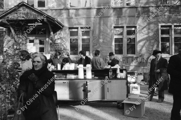 Image of sheet 19920010 photo 8: Flohmarkt im Kanzleischulhaus. Silvano Speranza fährt den Federlos Bus. Züglete vom Kanzlei. Plastik von Schang Hutter. Werbeplakat für Baer gescrached. Schulbänke liegen im Hof verbrannt. Rebecca Naldi. Schulhaus Portrait Kanzleischulhaus und brennende Schulbänke. Zürich 1992 pulte tables chairs burned fyer schule school 
housing occupation occupied house home protest swiss switzerland Schweiz Europe